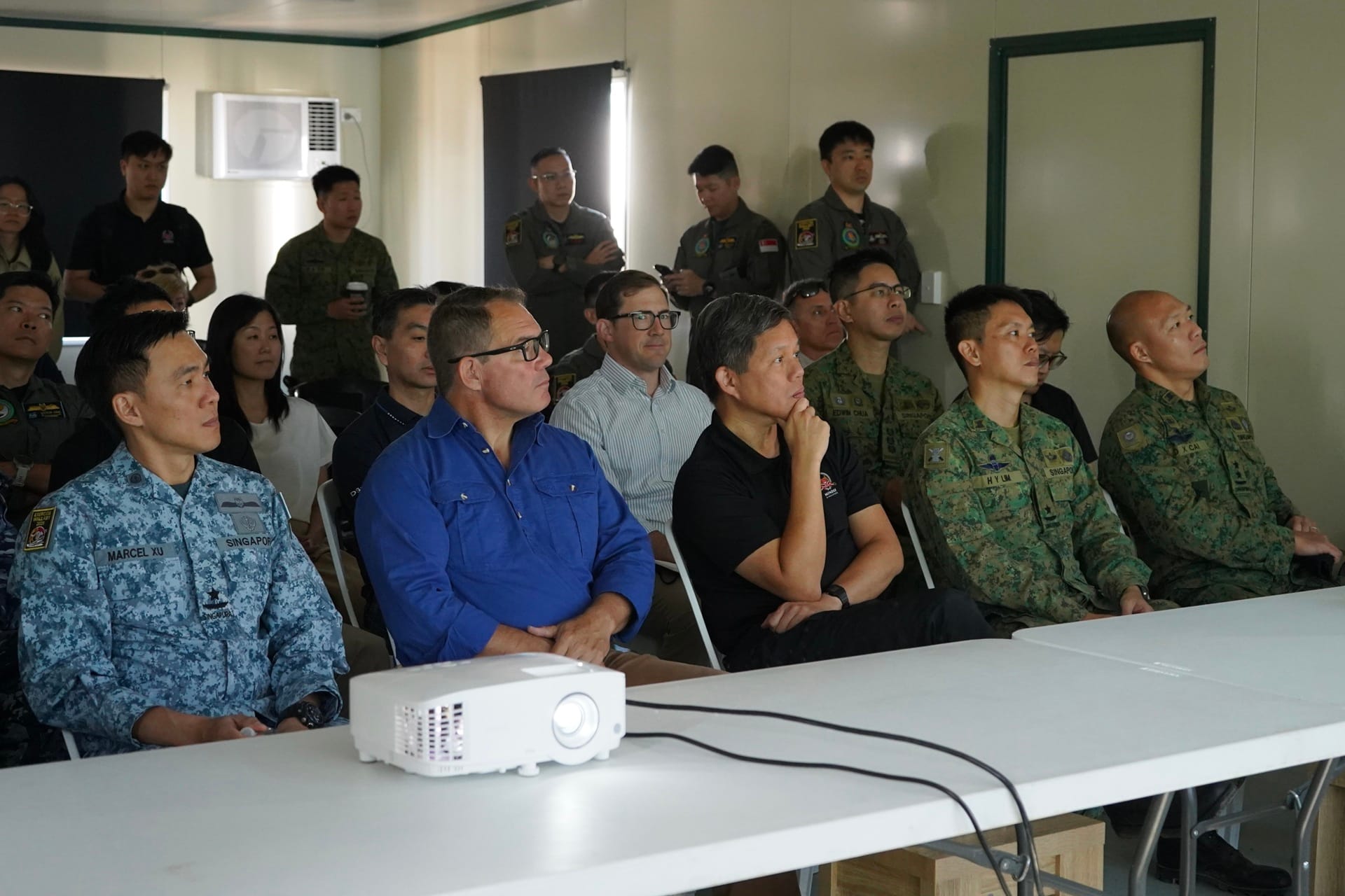 Mr Chan (third from right) and Mr Gosling (second from left) attended a brief on Exercise Wallaby 2025.